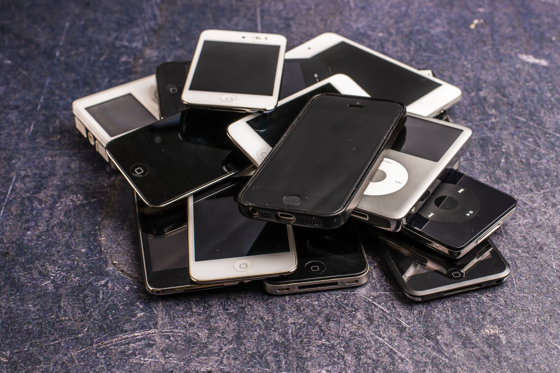 Assortment of older mobile phones with dark displays.
